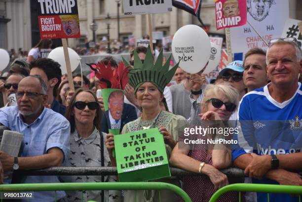 Demonstrators gather at Trafalgar Square as they attend a rally against the US President Donald Trumps visit to the UK, including a giant inflatable...