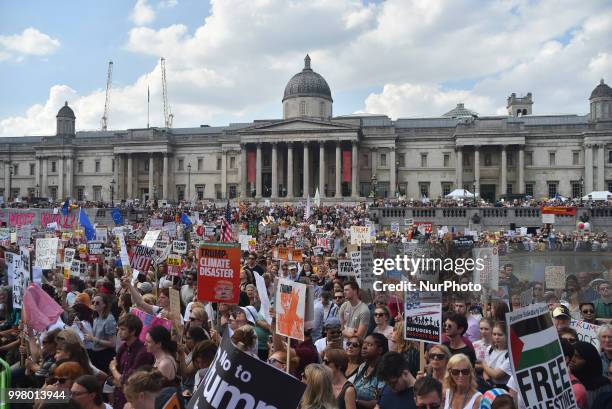 Demonstrators gather at Trafalgar Square as they attend a rally against the US President Donald Trumps visit to the UK, including a giant inflatable...