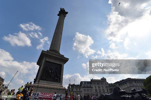 Demonstrators gather at Trafalgar Square as they attend a rally against the US President Donald Trumps visit to the UK, including a giant inflatable...