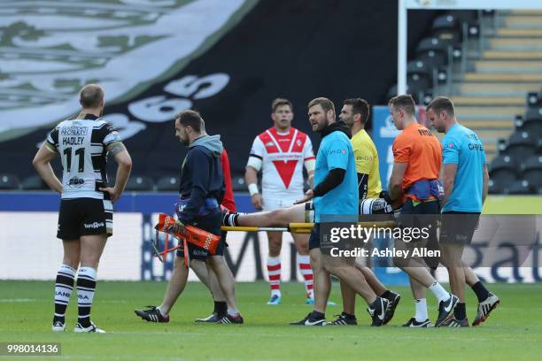 Jake Connor of Hull FC is carried off injured during the BetFred Super League match between Hull FC and St Helens Saints at the KCOM Stadium on July...