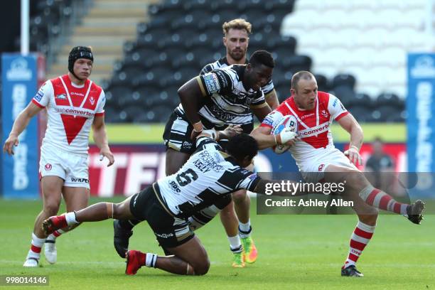 James Roby of St Helens gets away from Albert Kelly and Masi Matongo of Hull FC during the BetFred Super League match between Hull FC and St Helens...