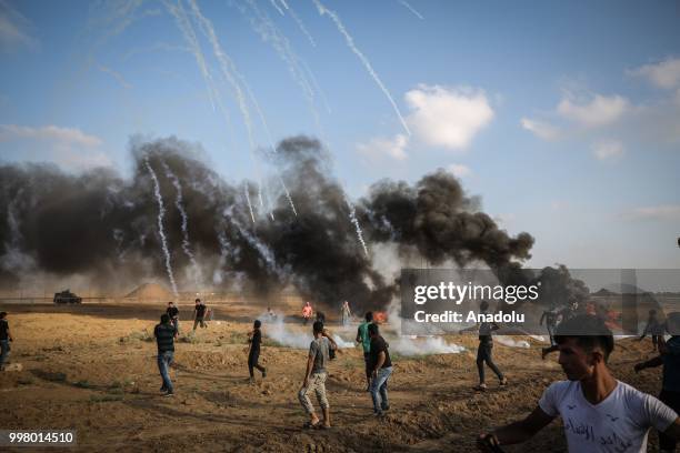 Israeli forces use tear gas to disperse Palestinian demonstrators taking part in the "Great March of Return" demonstration with ''Fidelity to Khan...