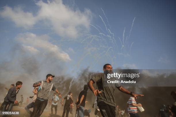 Israeli forces use tear gas to disperse Palestinian demonstrators taking part in the "Great March of Return" demonstration with ''Fidelity to Khan...