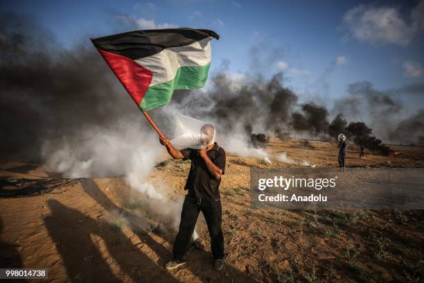 Israeli forces use tear gas to disperse Palestinian demonstrators taking part in the "Great March of Return" demonstration with ''Fidelity to Khan...