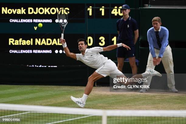 Serbia's Novak Djokovic returns against Spain's Rafael Nadal during their men's singles semi-final match on the eleventh day of the 2018 Wimbledon...
