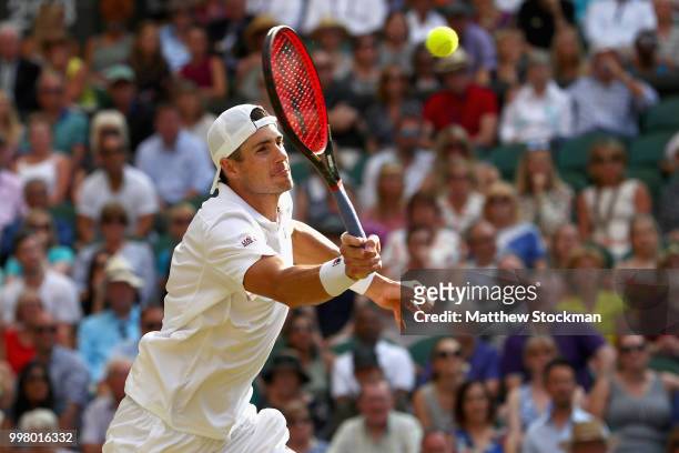 John Isner of The United States returns against Kevin Anderson of South Africa during their Men's Singles semi-final match on day eleven of the...