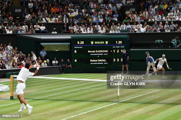 Spain's Rafael Nadal plays against Serbia's Novak Djokovic during their men's singles semi-final match on the eleventh day of the 2018 Wimbledon...