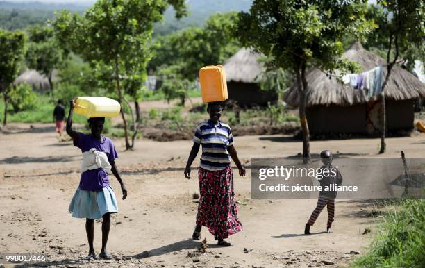 Women carry water in the Rhino Camp, a refugee camp for displaced children from South Sudan, in Ofua, Uganda, 9 August 2017. German foreign minister...