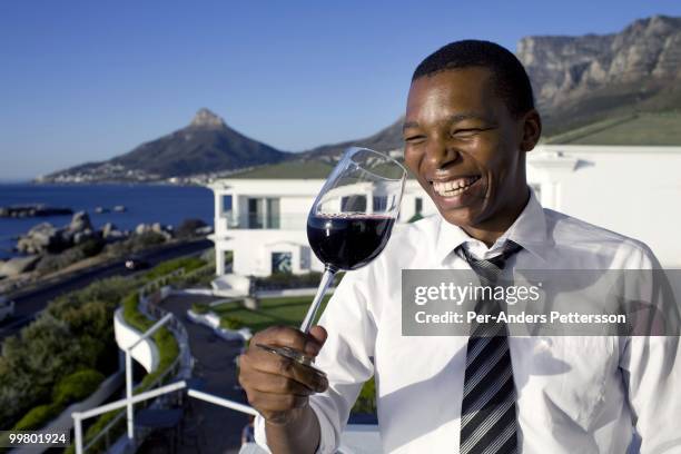 Luvo Ntezo, a wine sommelier at the Twelve Apostles Hotel, holds a glass of wine in the garden on March 23, 2010 in Cape Town, South Africa. Mr....