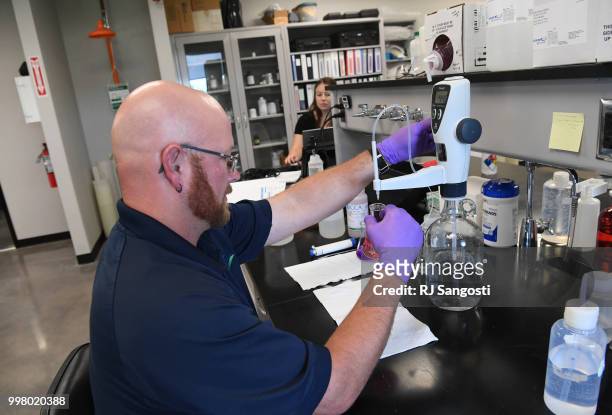 Jeremiah Lane, water systems operator with South Adams County Water and Sanitation District, work in the lab testing water at Klein Water Treatment...