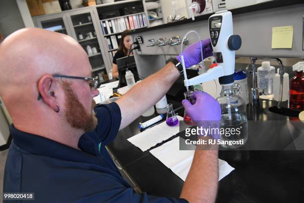 Jeremiah Lane, water systems operator with South Adams County Water and Sanitation District, work in the lab testing water at Klein Water Treatment...