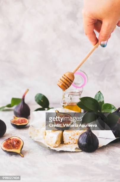blu cheese, figs and honey on a white marble table, selective focus - blu stock-fotos und bilder