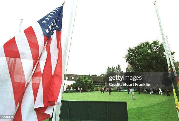 Players practice on the putting green in front of the flags raised to half mast at the Saint-nom-la-breteche Golf Club in Paris, France. Mandatory...