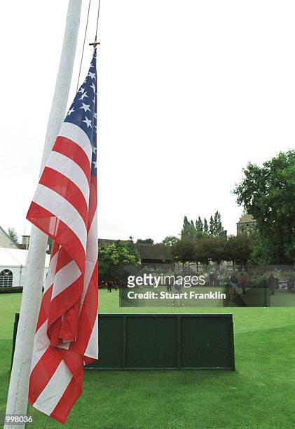 Players practice on the putting green in front of the flags raised to half mast at the Saint-nom-la-breteche Golf Club in Paris, France. Mandatory...