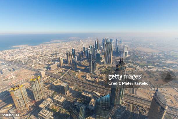 aerial view of downtown dubai from burj khalifa, dubai, united arab emirates. - burj stock-fotos und bilder