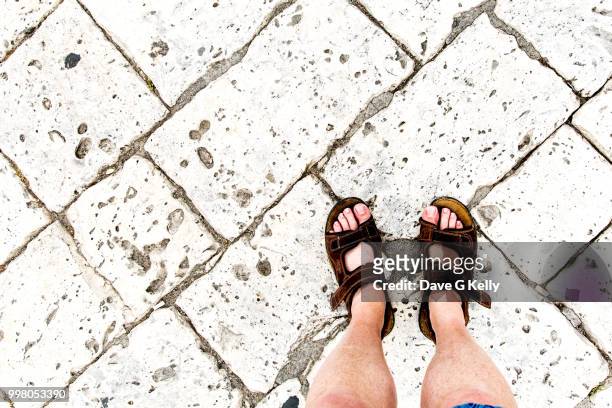 view of man wearing sandals from directly above - otranto foto e immagini stock