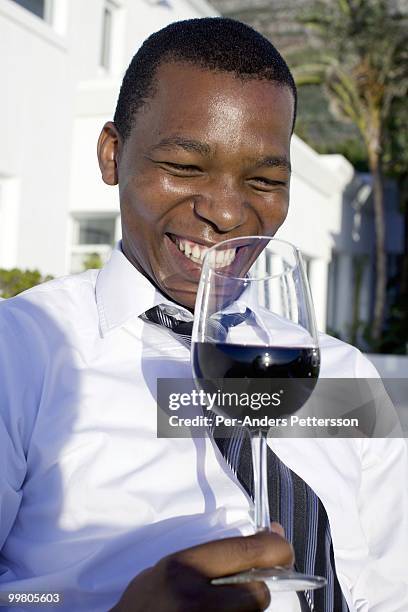 Luvo Ntezo, a wine sommelier at the Twelve Apostles Hotel, holds a glass of wine in the garden on March 23, 2010 in Cape Town, South Africa. Mr....