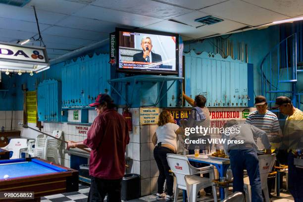 July 10. On the TV screen Andres Manuel Lopez Obrador talks about the visit of Mike Pompeo to Mexico while people play pool in a Bar near Hotel del...