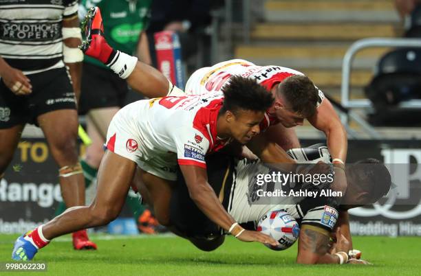 Regan Grace and Morgan Knowles of St Helens tackle Bureta Faraimo of Hull FC during the BetFred Super League match between Hull FC and St Helens...