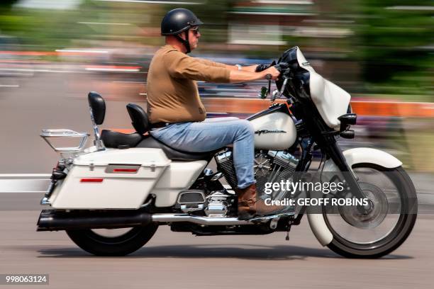 Man rides a Harley Davidson motorcycle through the streets of Port Dover, Ontario, during the Friday the 13th gathering on July 13 2018. - Every...