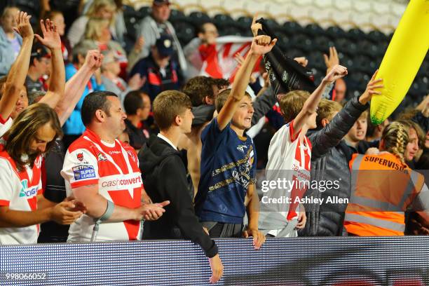 Fans of St Helens cheer on their team during the BetFred Super League match between Hull FC and St Helens Saints at the KCOM Stadium on July 13, 2018...