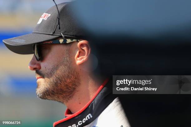 Paul Menard, driver of the Discount Tire Ford, stands on the grid during qualifying for the NASCAR Xfinity Series Alsco 300 at Kentucky Speedway on...