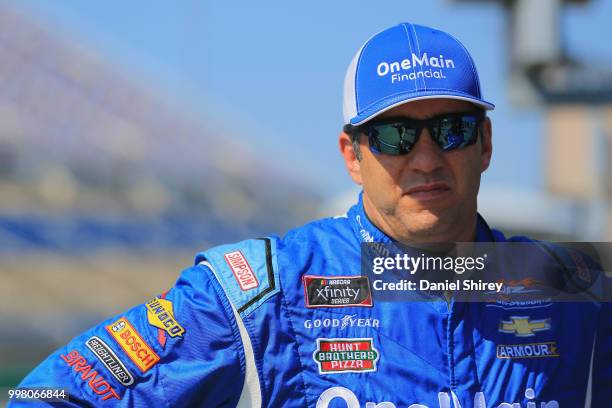 Elliott Sadler, driver of the OneMain Financial Chevrolet, stands on the grid during qualifying for the NASCAR Xfinity Series Alsco 300 at Kentucky...