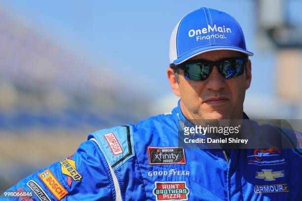 Elliott Sadler, driver of the OneMain Financial Chevrolet, stands on the grid during qualifying for the NASCAR Xfinity Series Alsco 300 at Kentucky...