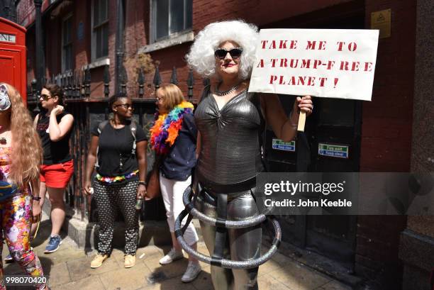 Demonstrator with an anti Trump placard saying "Take me to a Trump free planet" attends the Drag Protest Parade LGBTQi March against Trump on July...