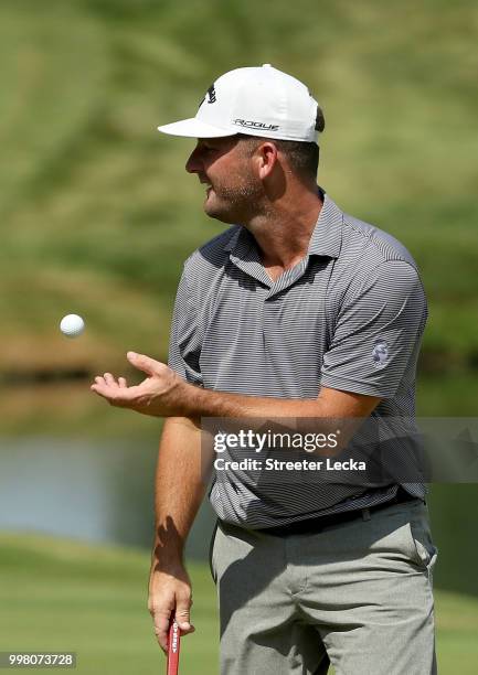 Matt Every tosses the ball to his caddie on the 18th hole during the second round of the John Deere Classic at TPC Deere Run on July 13, 2018 in...