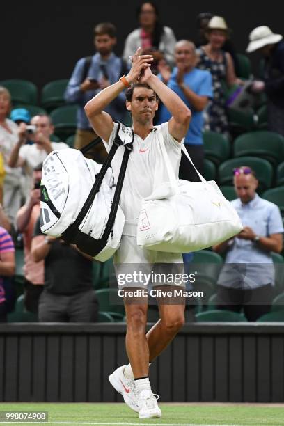 Rafael Nadal of Spain leaves Centre Court after his Men's Singles semi-final match against Novak Djokovic of Serbia was suspended on day eleven of...