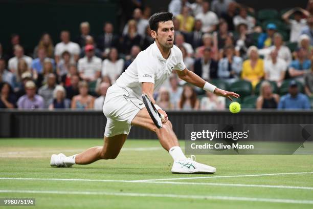 Novak Djokovic of Serbia returns against Rafael Nadal of Spain during their Men's Singles semi-final match on day eleven of the Wimbledon Lawn Tennis...