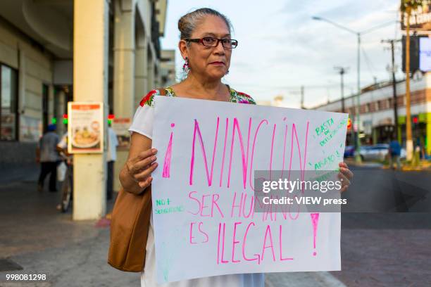 July 10: A woman holds a placard as demonstrators take part in a protest against U.S. President Donald Trump migration policies in the border between...