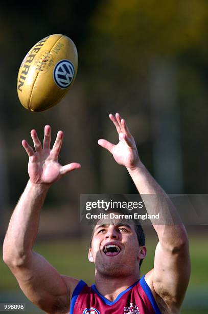 Daniel Bradshaw of the Brisbane Lions marks the ball on the sideline as his team mates train during the Brisbane Lions training session at Giffin...