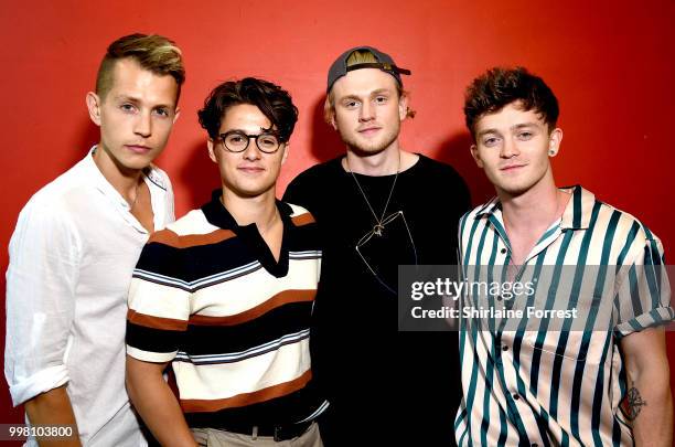 James McVey, Bradley Simpson, Tristan Evans and Connor Ball of The Vamps pose backstage after meeting fans and signing copies of their new album...