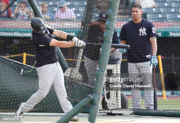 New York Yankees catcher Gary Sanchez looks on as Tyler Austin takes batting practice before the start of the game against the Cleveland Indians at...