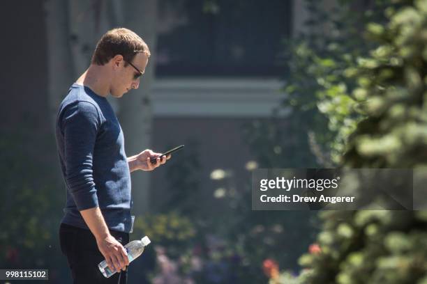 Mark Zuckerberg, chief executive officer of Facebook, checks his phone during the annual Allen & Company Sun Valley Conference, July 13, 2018 in Sun...