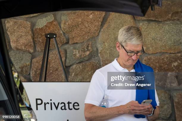 Tim Cook, chief executive officer of Apple, checks his iPhone during the annual Allen & Company Sun Valley Conference, July 13, 2018 in Sun Valley,...