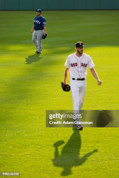 Bartolo Colon of the Texas Rangers and Chris Sale of the Boston Red Sox warm up in the outfield before a game at Fenway Park on July 11, 2018 in...