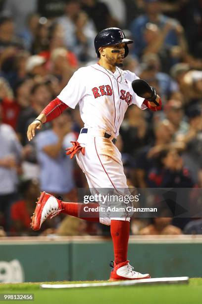 Mookie Betts of the Boston Red Sox scores in the fifth inning of a game against the Texas Rangers at Fenway Park on July 11, 2018 in Boston,...