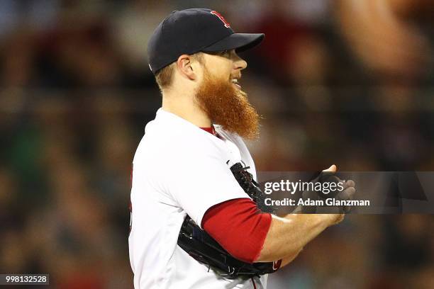 Craig Kimbrel of the Boston Red Sox reacts after walking in a run in the eighth inning of a game against the Texas Rangers at Fenway Park on July 11,...