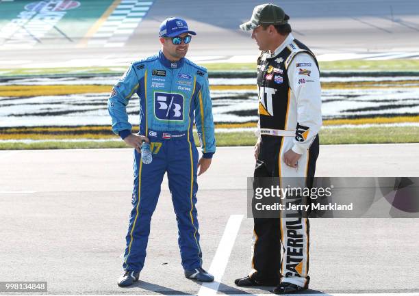 Ricky Stenhouse Jr., driver of the Fifth Third Bank Ford, talks to Ryan Newman, driver of the Caterpillar Chevrolet, on the grid during qualifying...