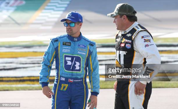 Ricky Stenhouse Jr., driver of the Fifth Third Bank Ford, talks to Ryan Newman, driver of the Caterpillar Chevrolet, on the grid during qualifying...