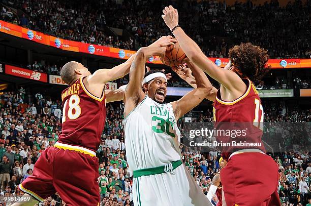 Rasheed Wallace of the Boston Celtics gets tied up by Anthony Parker and Anderson Varejao of the Cleveland Cavaliers in Game Four of the Eastern...