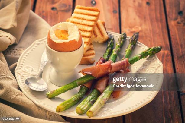 grilled asparagus wrapped in prosciutto - prosciutto wrapped stock pictures, royalty-free photos & images