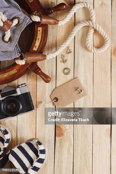 striped slippers, camera, bag and maritime decorations on the wooden background - camera bag stock-fotos und bilder