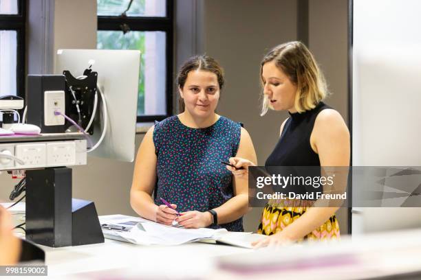 female science researchers discussing work - freund stock pictures, royalty-free photos & images