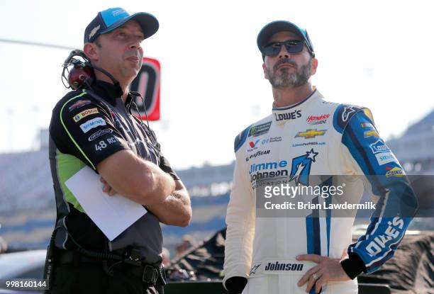 Jimmie Johnson, driver of the Lowe's/Jimmie Johnson Foundation Chevrolet, talks to crew chief Chad Knaus on the grid during qualifying for the...