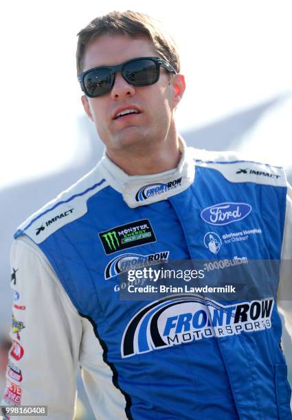 David Ragan, driver of the MDS Transport Ford, stands on the grid during qualifying for the Monster Energy NASCAR Cup Series Quaker State 400...