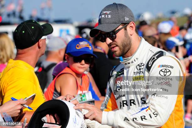 Daniel Suarez Joe Gibbs Racing Toyota Camry signs an autograph for a fan before the start of qualifying for the Monster Energy NASCAR Cup Series...